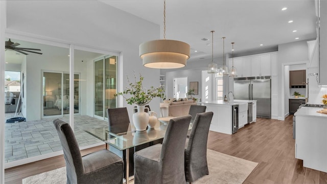 1529 Rio Vista Ter, Parrish, FL 34219 - dining room with wine cooler, recessed lighting, ceiling fan, and light wood finished floors