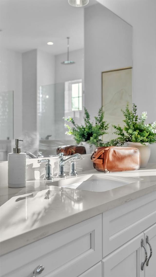 bathroom featuring vanity and a shower