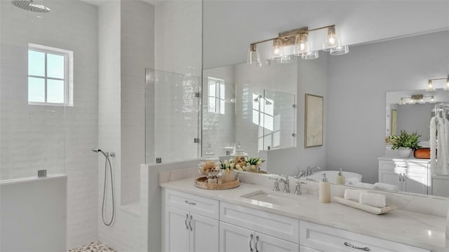 bathroom featuring vanity and tiled shower