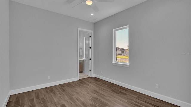1529 Rio Vista Ter, Parrish, FL 34219 - unfurnished bedroom with wood finished floors, baseboards, ensuite bathroom, ceiling fan, and recessed lighting