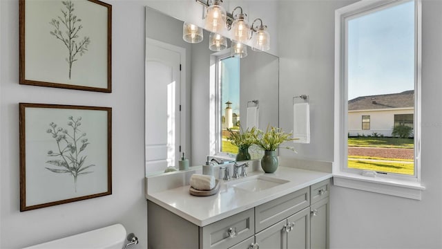 bathroom with vanity, plenty of natural light, and toilet