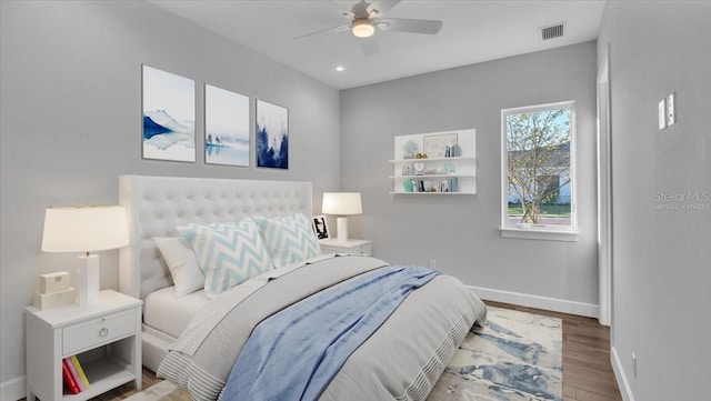 bedroom with ceiling fan and hardwood / wood-style floors