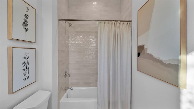 bathroom featuring toilet and shower / bath combo with shower curtain