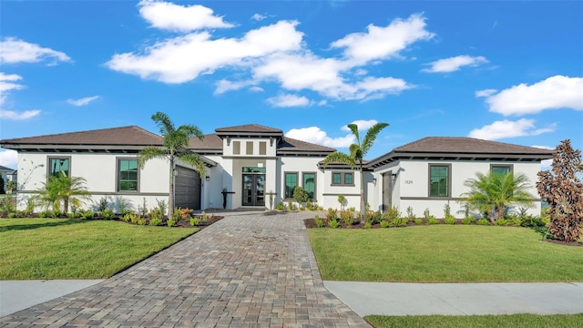 1529 Rio Vista Ter, Parrish, FL 34219 - prairie-style house with an attached garage, stucco siding, a front yard, decorative driveway, and french doors