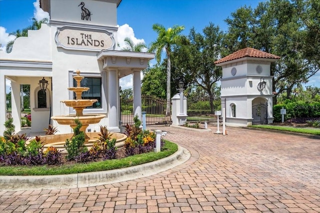1529 Rio Vista Ter, Parrish, FL 34219 - view of home's community with curved driveway, fence, and a gate