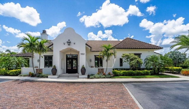 1529 Rio Vista Ter, Parrish, FL 34219 - mediterranean / spanish house with a chimney, french doors, a tile roof, uncovered parking, and stucco siding