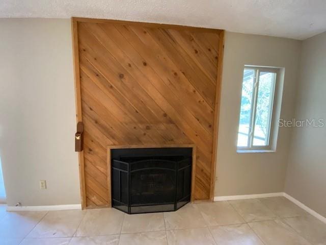 details featuring a textured ceiling and a wood stove