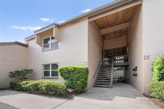 doorway to property with stucco siding