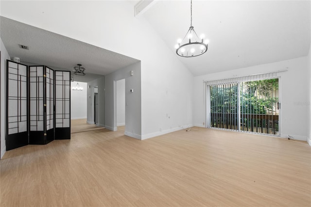 unfurnished living room featuring beamed ceiling, high vaulted ceiling, an inviting chandelier, and light hardwood / wood-style floors