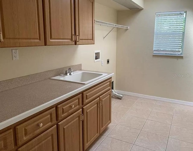 washroom featuring light tile patterned floors, hookup for a washing machine, cabinet space, hookup for an electric dryer, and a sink