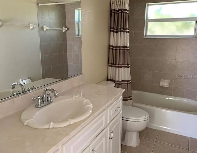 full bathroom featuring toilet, shower / bath combo, vanity, and tile patterned flooring