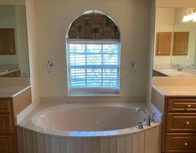 bathroom with vanity and a whirlpool tub