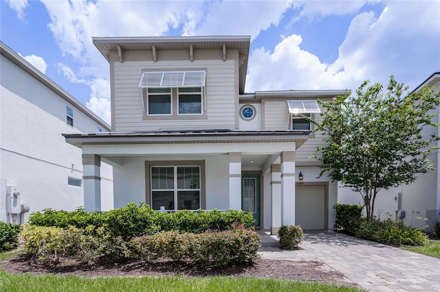 view of front of house with a porch and a garage