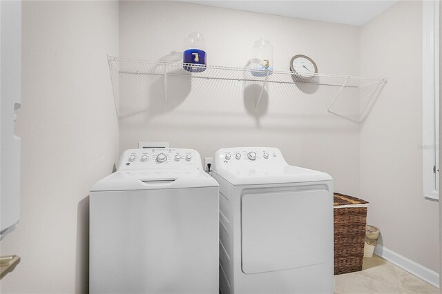 washroom featuring separate washer and dryer and light tile patterned floors