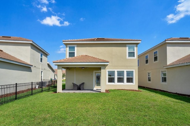 rear view of house featuring a patio and a lawn