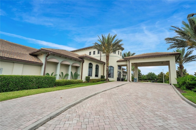 mediterranean / spanish house featuring a carport