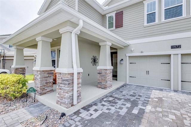 entrance to property with a garage and a porch