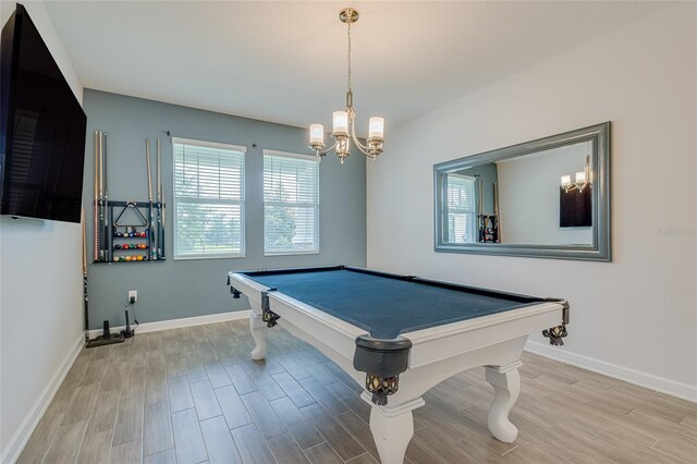 playroom with a notable chandelier, light hardwood / wood-style flooring, and billiards