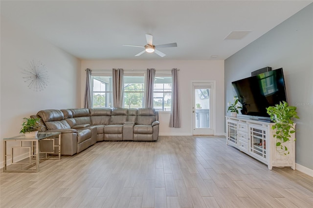 living room featuring ceiling fan and light wood-type flooring