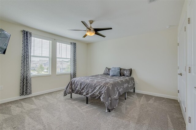 carpeted bedroom with ceiling fan