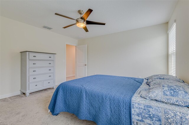 bedroom featuring light colored carpet and ceiling fan