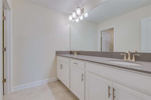 bathroom featuring tile patterned floors and dual bowl vanity