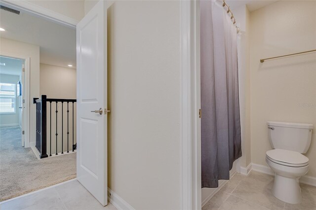 bathroom featuring toilet and tile patterned floors