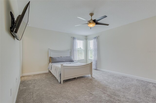 bedroom with light carpet and ceiling fan