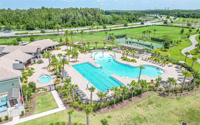 view of pool with a lawn