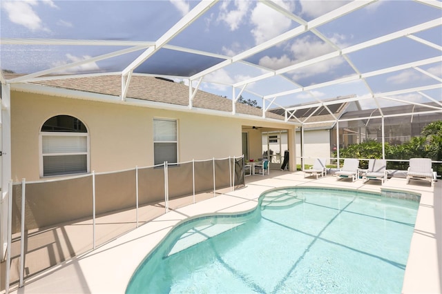 view of swimming pool featuring a lanai and a patio area