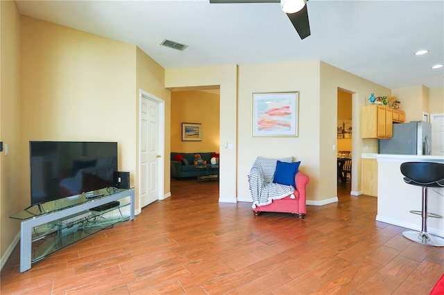 sitting room featuring ceiling fan and light wood-type flooring