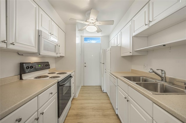 kitchen featuring white cabinetry, sink, light wood-type flooring, ceiling fan, and white appliances