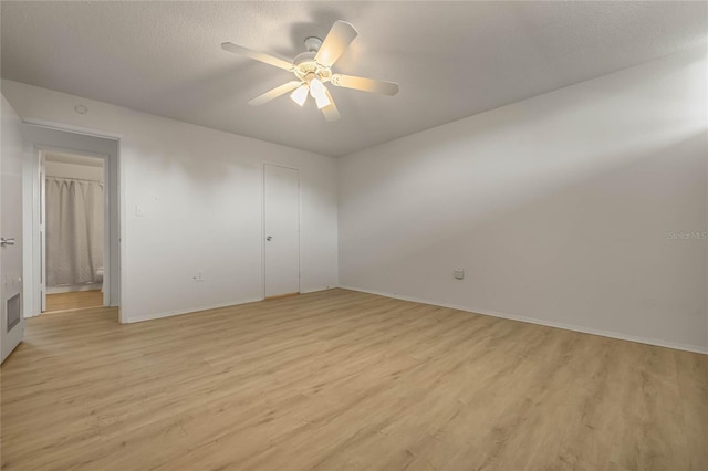 unfurnished bedroom with ceiling fan, light hardwood / wood-style flooring, and a textured ceiling