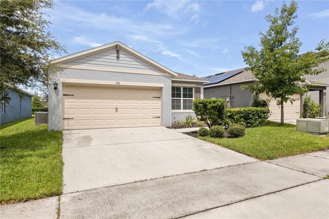 ranch-style house with a front yard, a garage, central AC unit, and solar panels