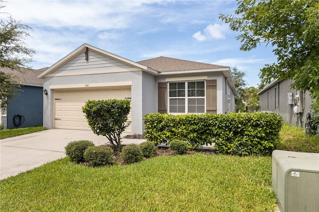 view of front of house with a garage and a front yard