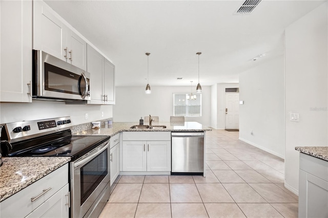 kitchen featuring appliances with stainless steel finishes, kitchen peninsula, sink, and white cabinets