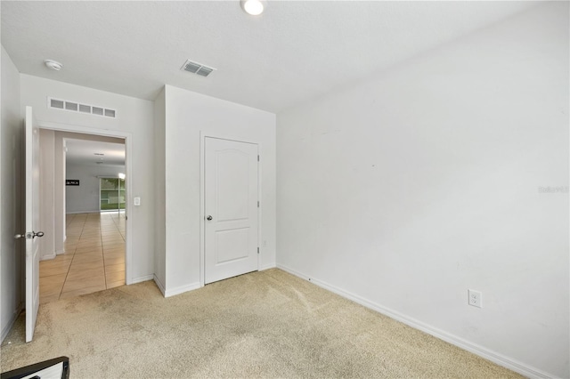 unfurnished bedroom featuring light colored carpet