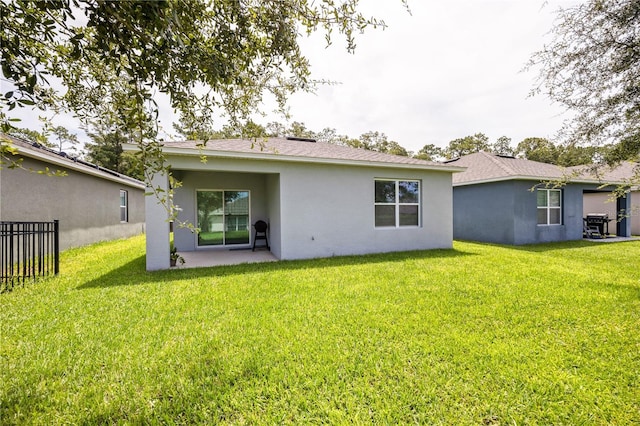 rear view of house with a yard