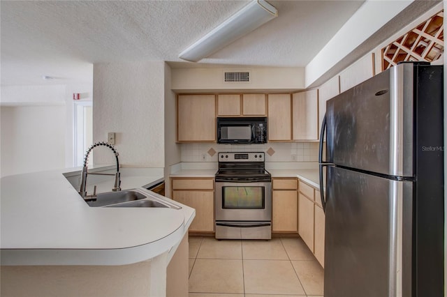 kitchen with tasteful backsplash, kitchen peninsula, stainless steel appliances, light brown cabinetry, and sink