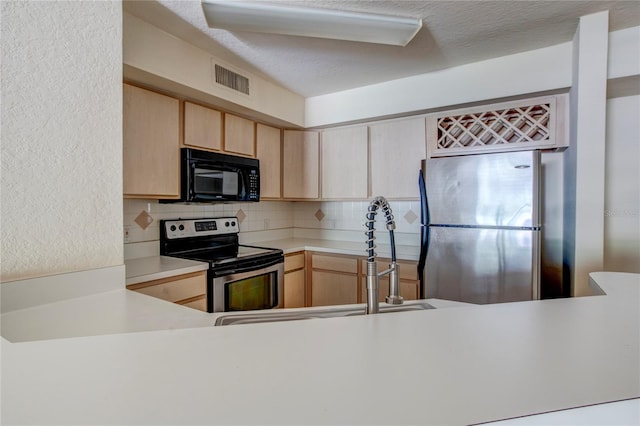 kitchen featuring tasteful backsplash, sink, appliances with stainless steel finishes, and light brown cabinetry