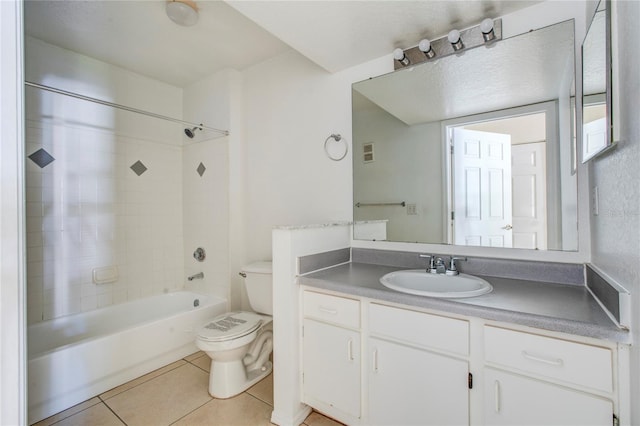 full bathroom featuring vanity, tile patterned floors, tiled shower / bath, and toilet