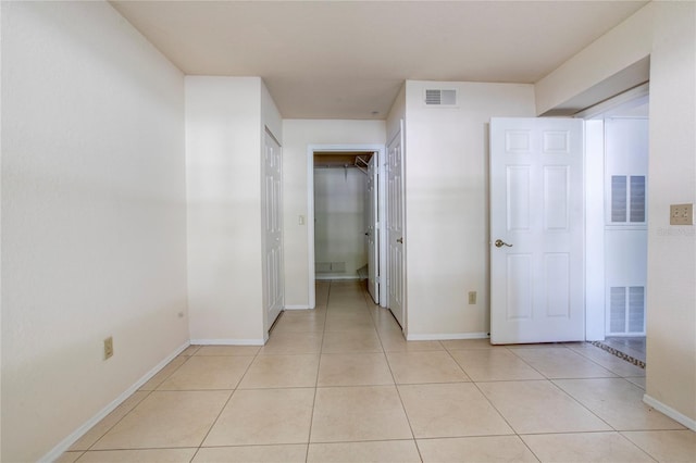 hall with light tile patterned flooring