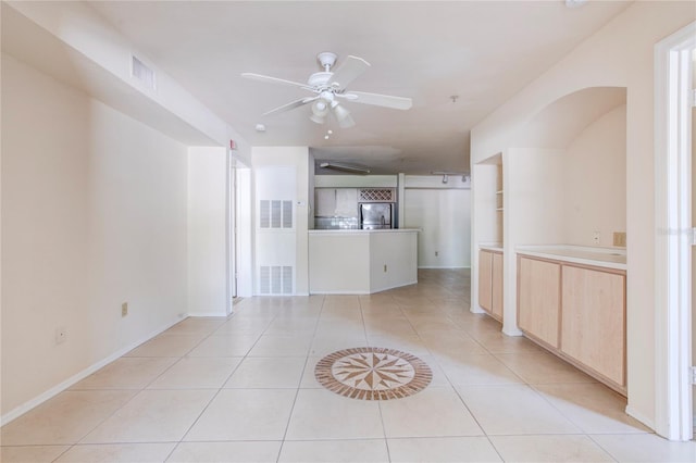 unfurnished living room with light tile patterned floors and ceiling fan