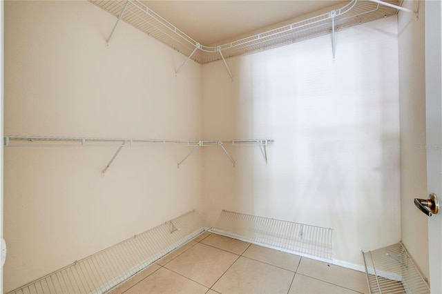 spacious closet with light tile patterned floors