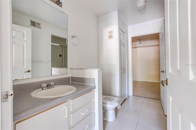 bathroom featuring tile patterned floors, vanity, and toilet