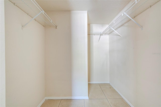 spacious closet with light tile patterned flooring