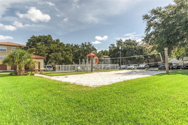 view of community with a yard and volleyball court