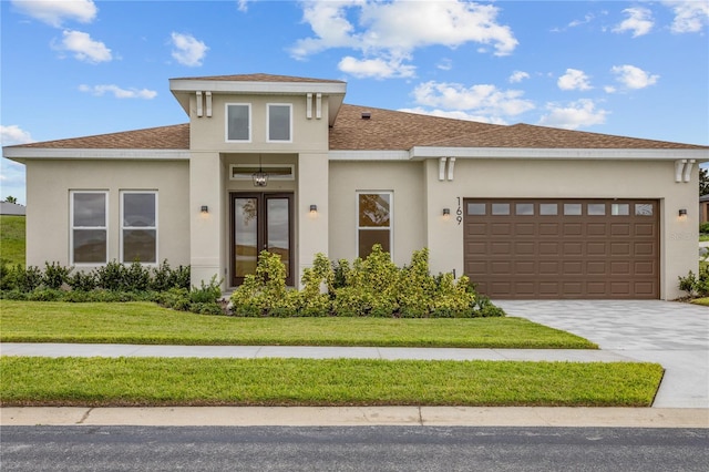 view of front facade with a front yard and a garage