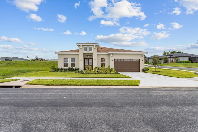 prairie-style home with a front lawn and a garage