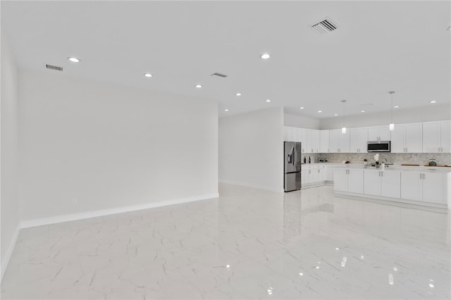 unfurnished living room with baseboards, visible vents, and marble finish floor